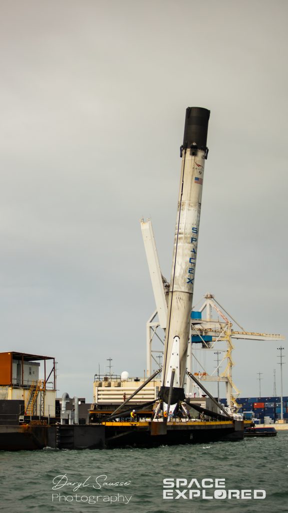 Falcon 9 booster from Crew-1 launch returns to port weathered and leaning